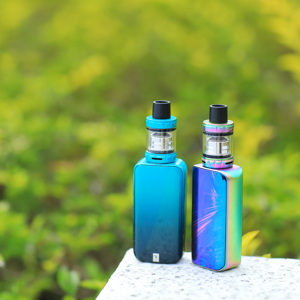 Vaporesso LUXE Nano Mod in gradient blue and rainbow finishes, with matching tanks, product shot.