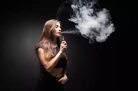 Vaporesso logo on a woman using a vape mod, exhaling a large cloud of vapor.